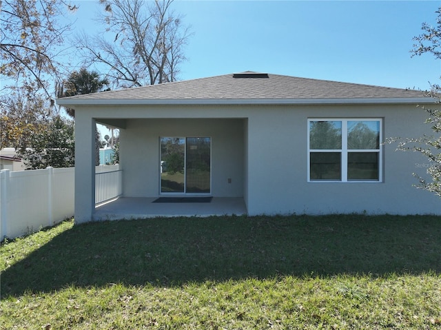 rear view of house featuring a yard and a patio area