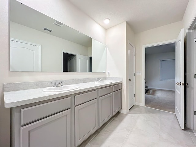 bathroom featuring tile patterned flooring, vanity, and a textured ceiling