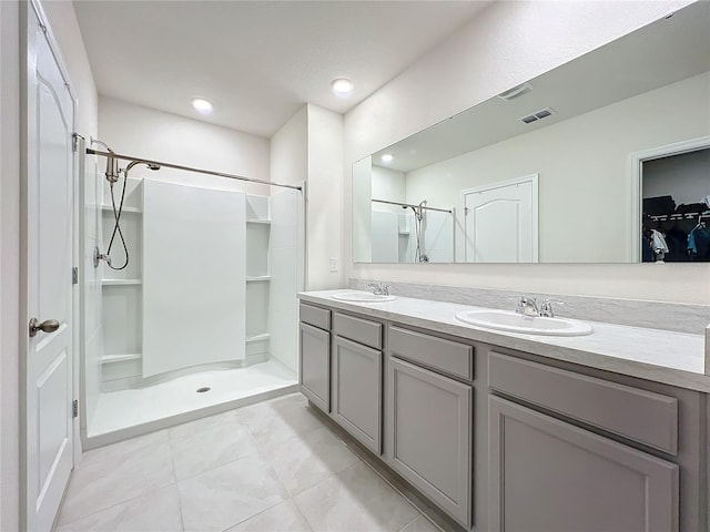 bathroom with vanity, tile patterned floors, and walk in shower