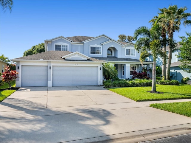 view of front of property with a garage and a front lawn