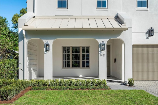 doorway to property with a lawn