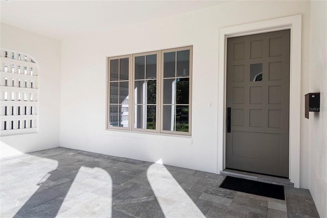 property entrance featuring a patio area