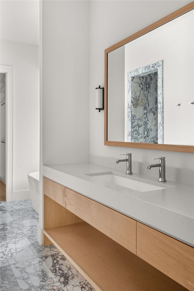 bathroom featuring vanity and a tub