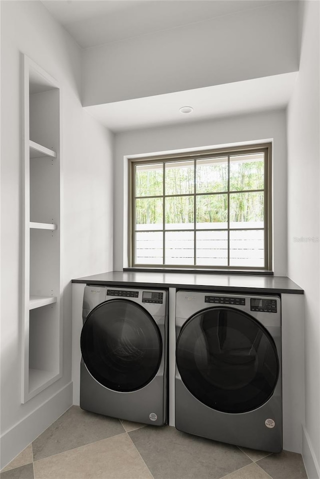 laundry room featuring a wealth of natural light and independent washer and dryer