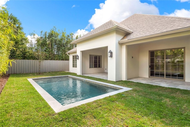 back of house featuring a fenced in pool, a yard, and a patio