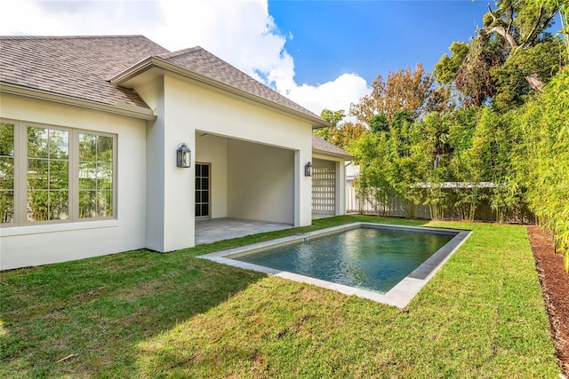 view of swimming pool featuring a lawn and a patio