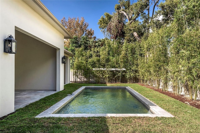 view of swimming pool featuring a yard and a patio