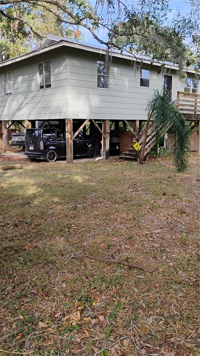 back of house featuring a carport