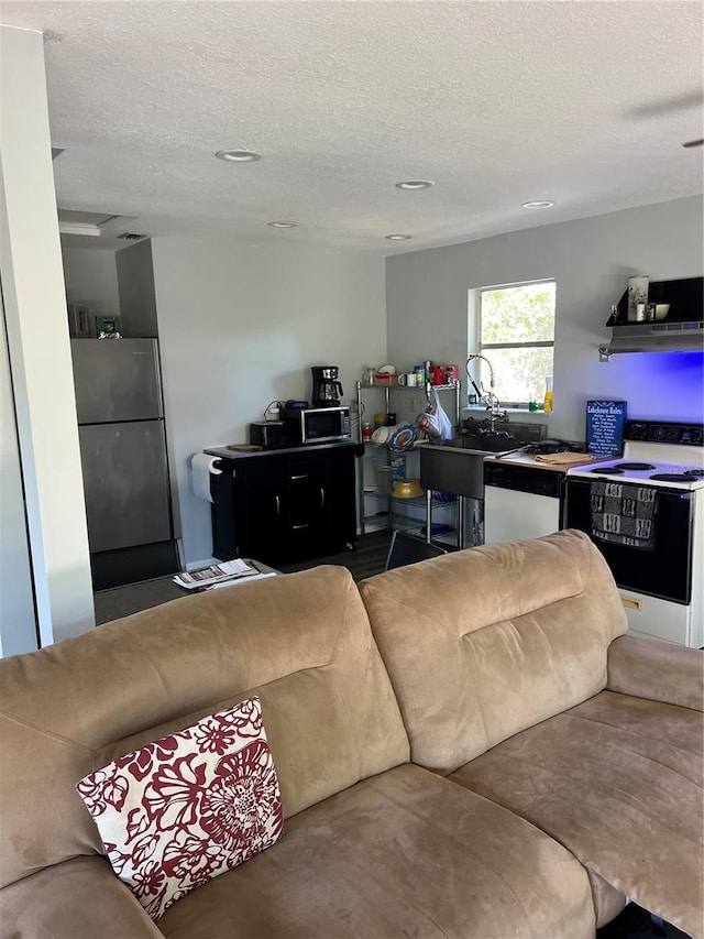 carpeted living room featuring a textured ceiling