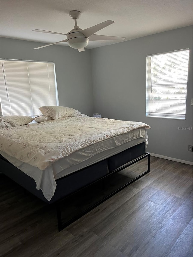 bedroom featuring ceiling fan and dark hardwood / wood-style flooring