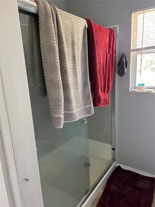 bathroom with a shower with door