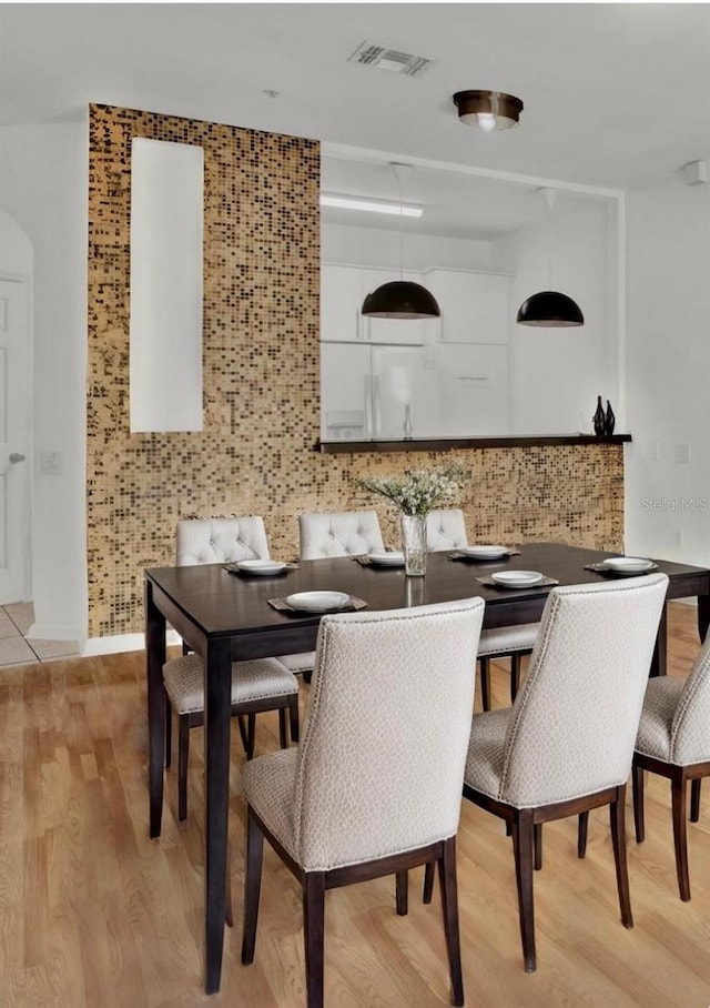 dining space with light wood-type flooring