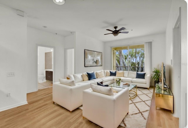 living room with ceiling fan and light wood-type flooring