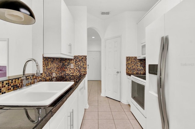 kitchen featuring white cabinets, white appliances, and sink