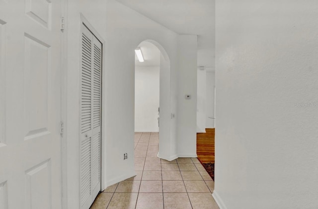 hall featuring light tile patterned floors