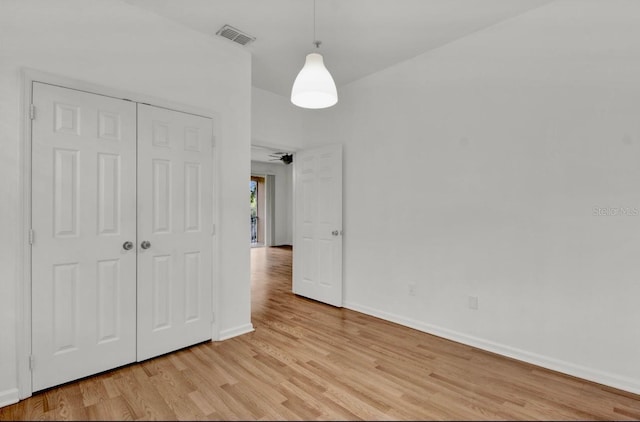 unfurnished bedroom featuring a closet and light wood-type flooring