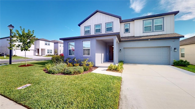 view of front of home featuring a front yard and a garage