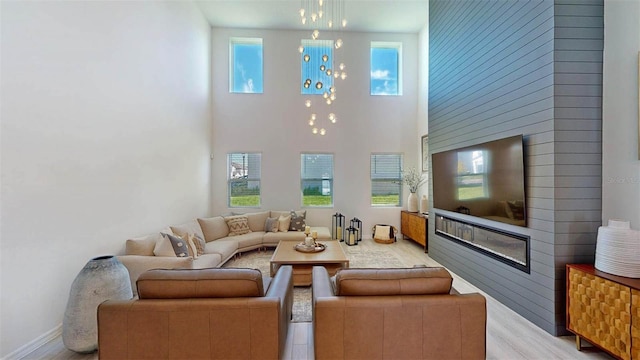 living room featuring a high ceiling and light wood-type flooring