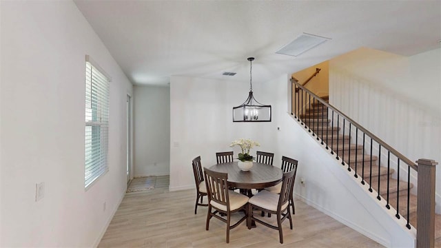 dining space featuring a chandelier and light wood-type flooring