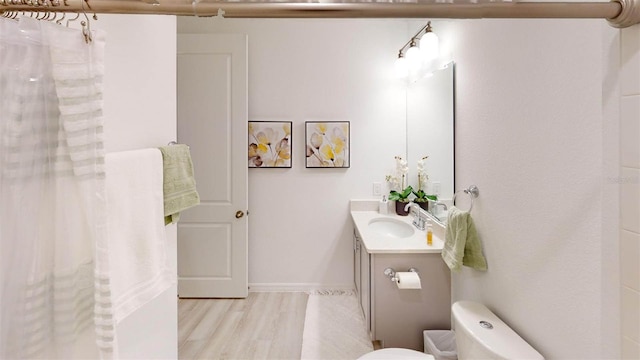 bathroom featuring hardwood / wood-style floors, vanity, and toilet