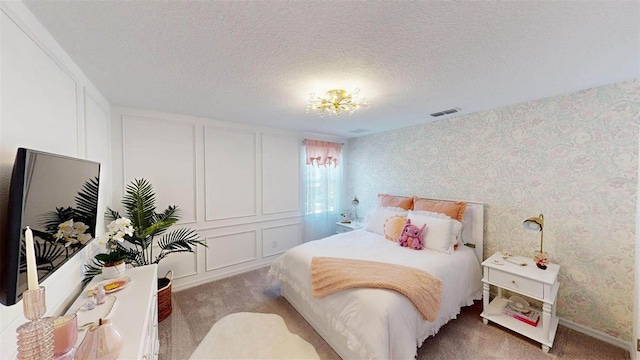 carpeted bedroom featuring a textured ceiling