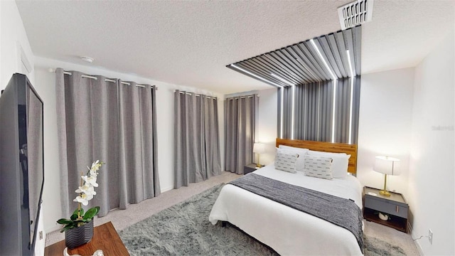 bedroom with hardwood / wood-style floors and a textured ceiling