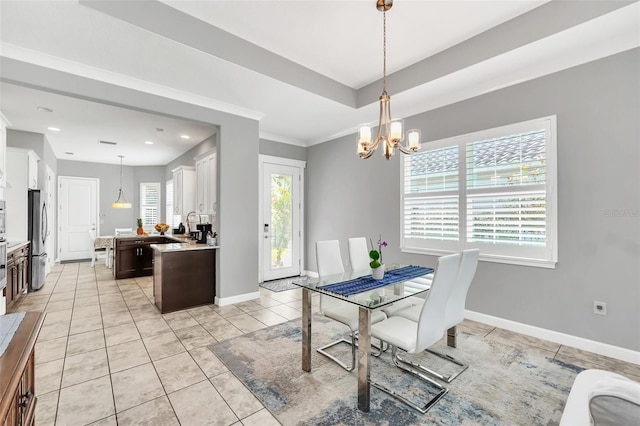 dining space featuring light tile patterned flooring, ornamental molding, and an inviting chandelier