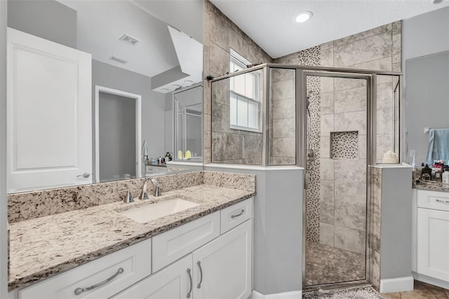 bathroom with vanity and walk in shower