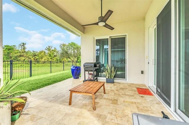 view of patio featuring ceiling fan and a grill