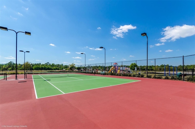 view of tennis court with basketball hoop