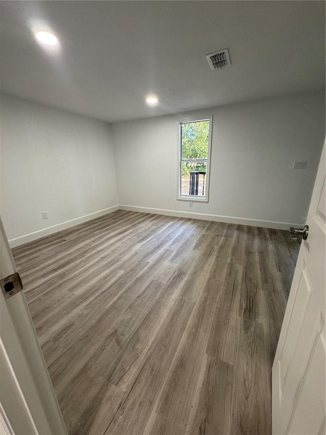 spare room with dark hardwood / wood-style floors