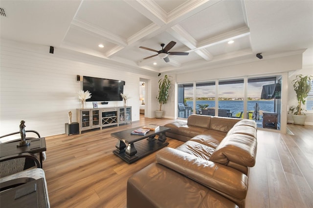 living room with coffered ceiling, crown molding, hardwood / wood-style flooring, ceiling fan, and beamed ceiling