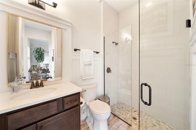 bathroom with vanity, toilet, wood-type flooring, and walk in shower