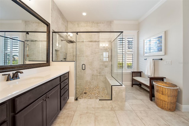 bathroom with tile patterned floors, vanity, an enclosed shower, and crown molding