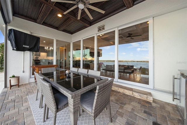 view of patio featuring ceiling fan and a water view