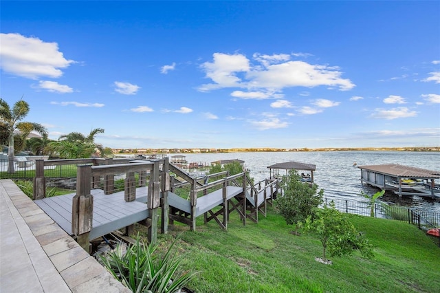 view of dock featuring a water view and a lawn