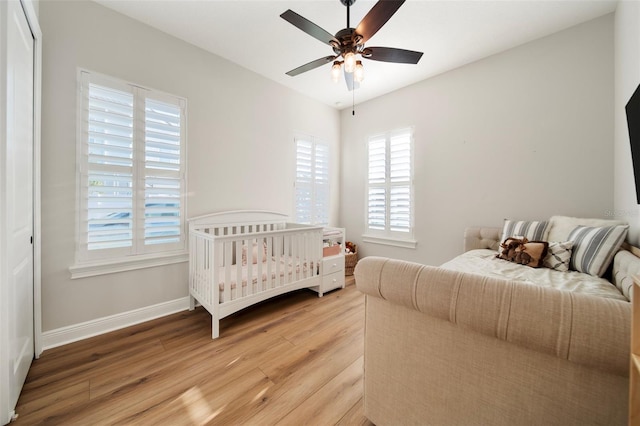 bedroom featuring a closet, light hardwood / wood-style flooring, and ceiling fan