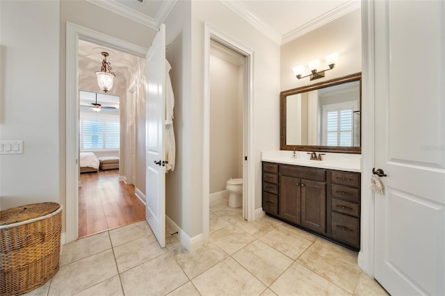 bathroom featuring crown molding, vanity, hardwood / wood-style flooring, and toilet