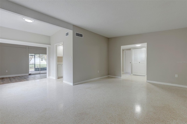 empty room with a textured ceiling