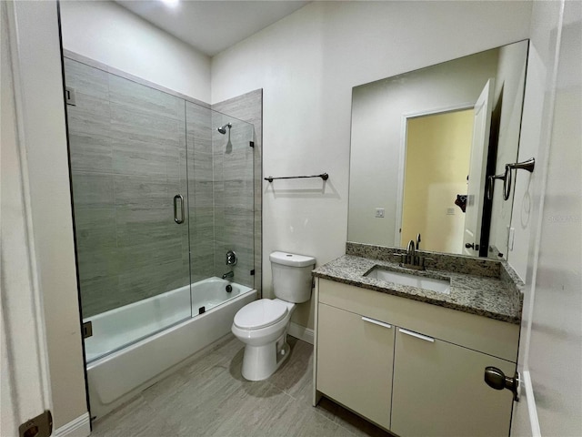 full bathroom with hardwood / wood-style flooring, vanity, toilet, and enclosed tub / shower combo