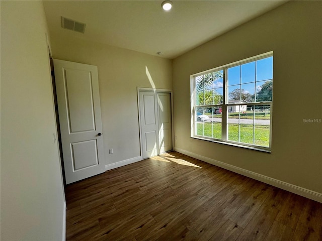 empty room with dark hardwood / wood-style floors