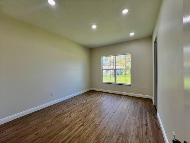 spare room with hardwood / wood-style floors