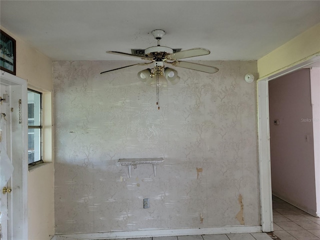 empty room featuring ceiling fan and light tile patterned floors