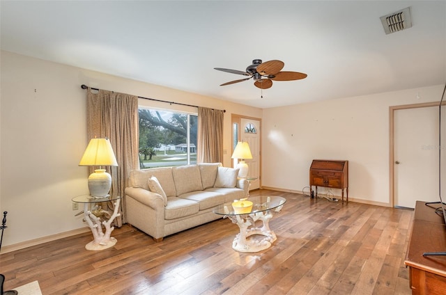 living room featuring hardwood / wood-style floors and ceiling fan