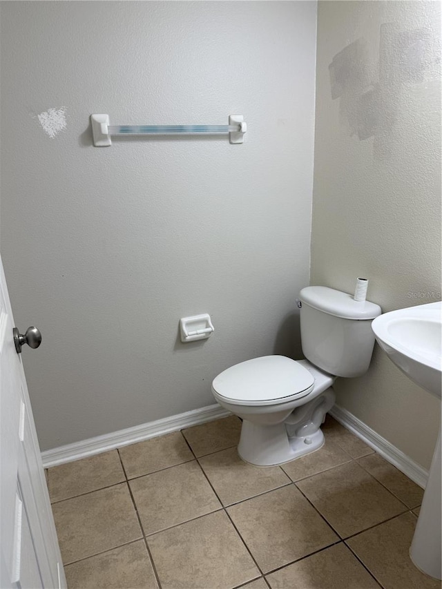 bathroom featuring tile patterned flooring and toilet