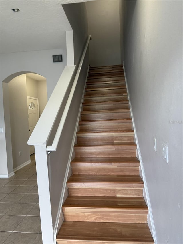 staircase with tile patterned floors