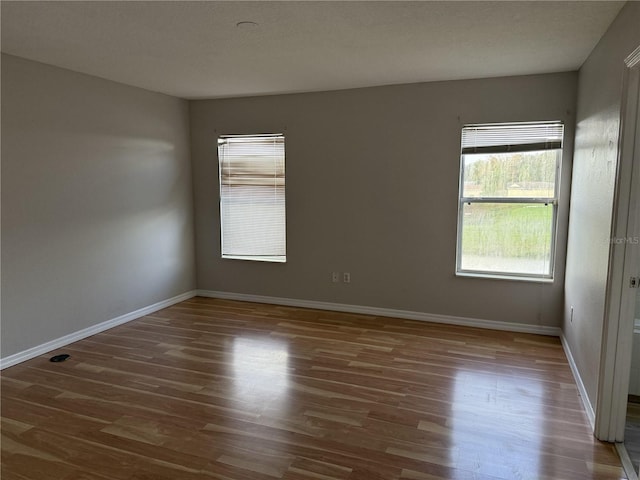 unfurnished room featuring dark wood-type flooring