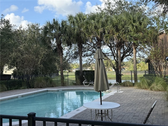 view of swimming pool featuring a patio area