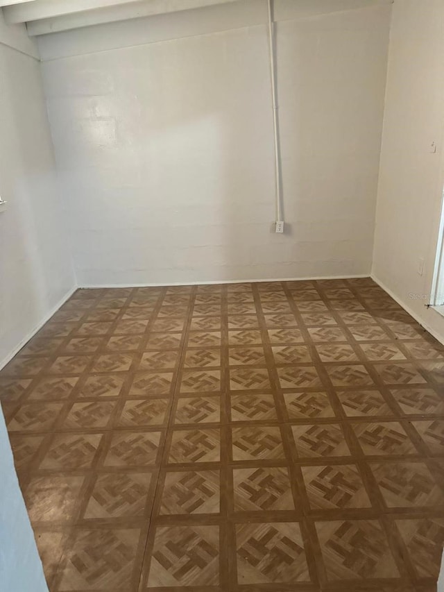 unfurnished room with dark parquet flooring