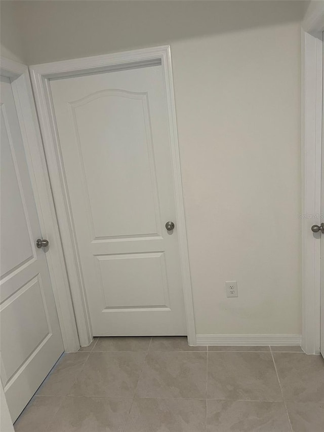 hall featuring light tile patterned flooring